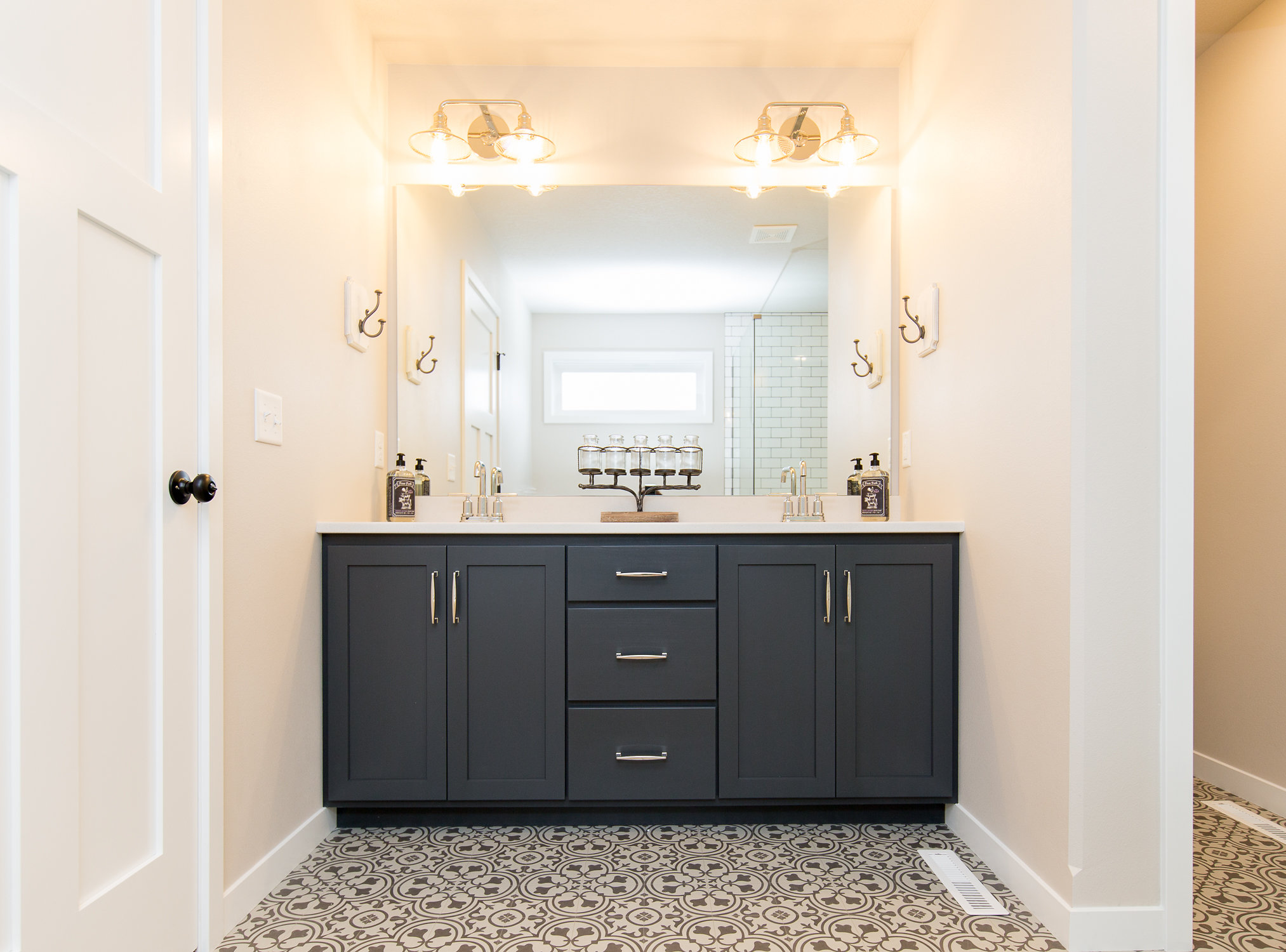 Blue bathroom cabinets and decorative flooring.jpg